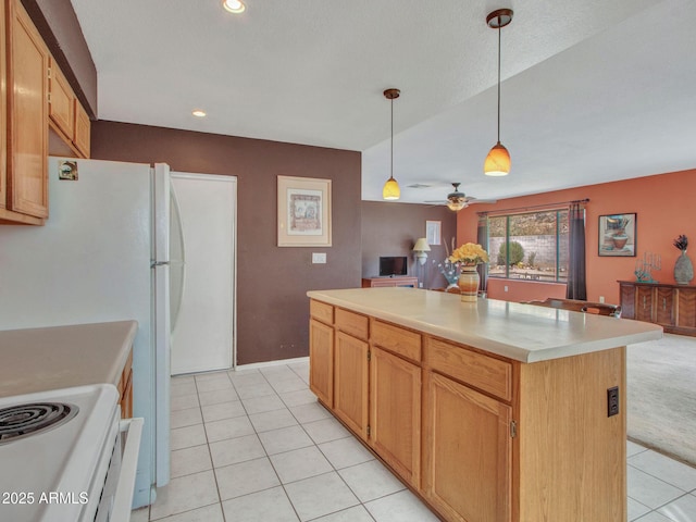 kitchen featuring pendant lighting, a center island, ceiling fan, and light tile patterned flooring