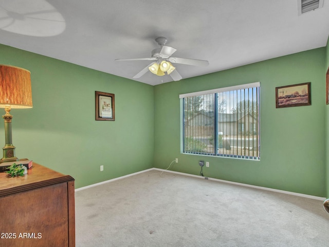 carpeted empty room featuring ceiling fan