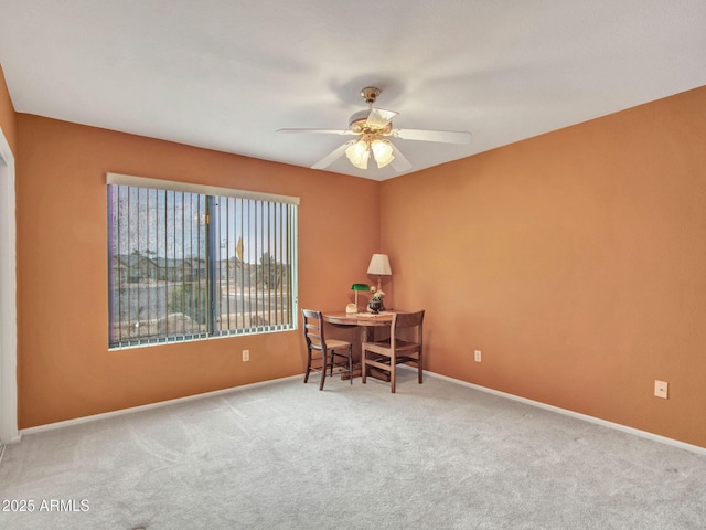 office space with light carpet and ceiling fan