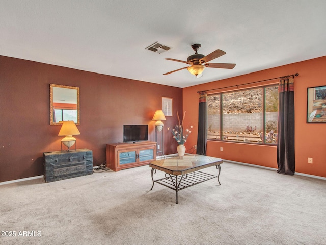 carpeted living room with ceiling fan