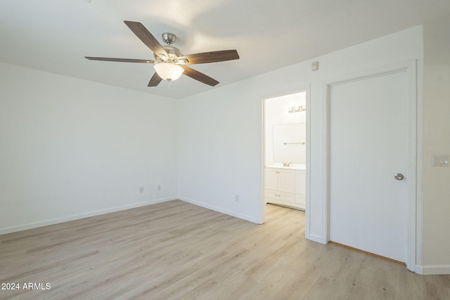 unfurnished bedroom featuring ceiling fan, sink, connected bathroom, and light hardwood / wood-style flooring