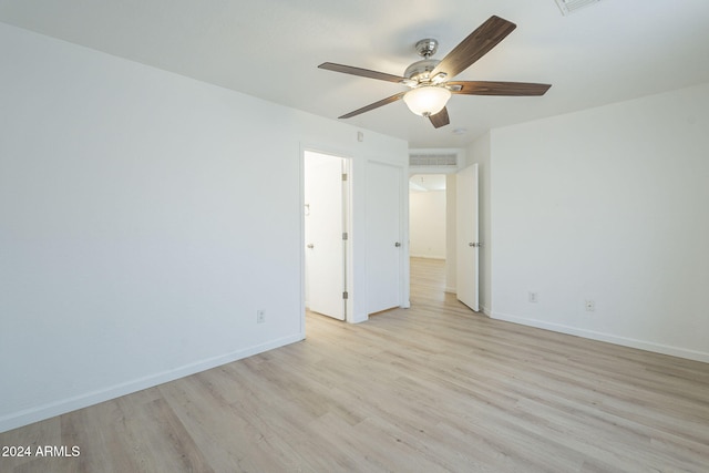 spare room featuring ceiling fan and light hardwood / wood-style flooring