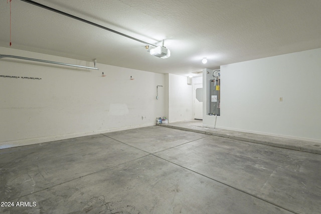 garage featuring water heater and a garage door opener