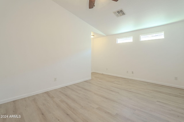 spare room featuring ceiling fan, light hardwood / wood-style floors, and lofted ceiling