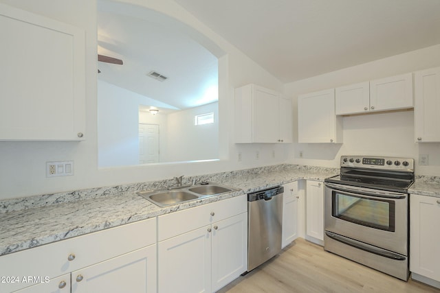 kitchen with white cabinetry, lofted ceiling, sink, and appliances with stainless steel finishes