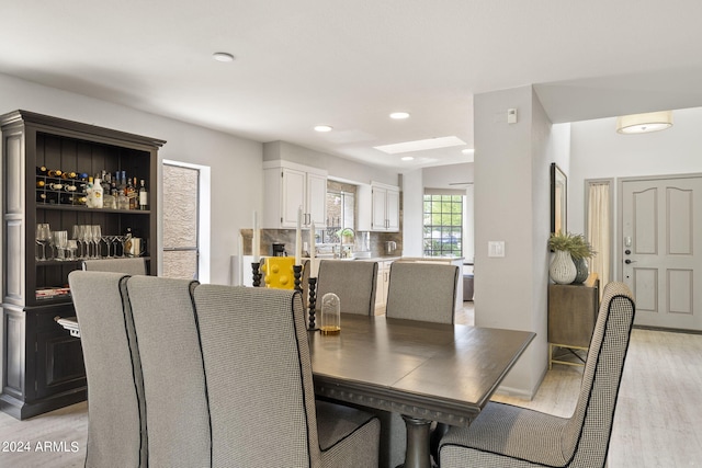 dining room featuring sink and light hardwood / wood-style floors