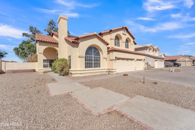 mediterranean / spanish-style house featuring a garage