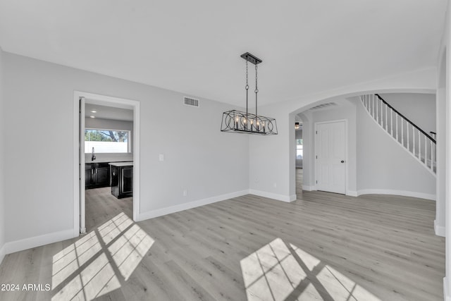 unfurnished dining area with light wood-type flooring