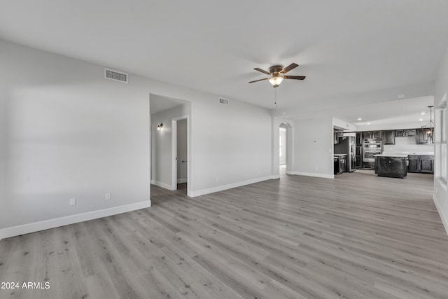 unfurnished living room with ceiling fan and light hardwood / wood-style flooring