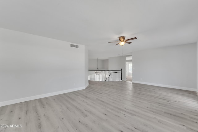 unfurnished living room with ceiling fan and light hardwood / wood-style flooring