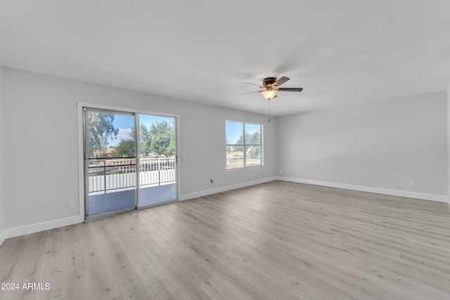 empty room featuring ceiling fan and light hardwood / wood-style floors