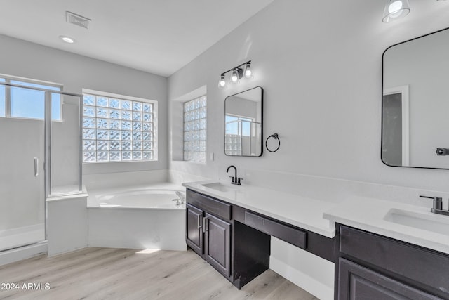 bathroom with vanity, separate shower and tub, and wood-type flooring