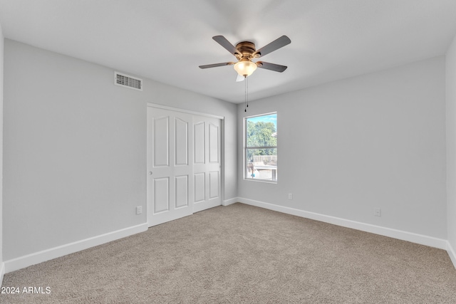 spare room featuring carpet flooring and ceiling fan