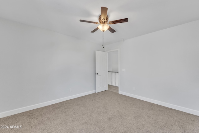 carpeted spare room with ceiling fan