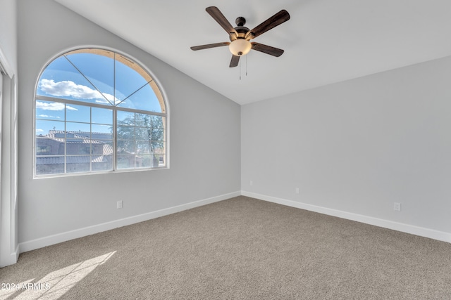 unfurnished room with ceiling fan and carpet