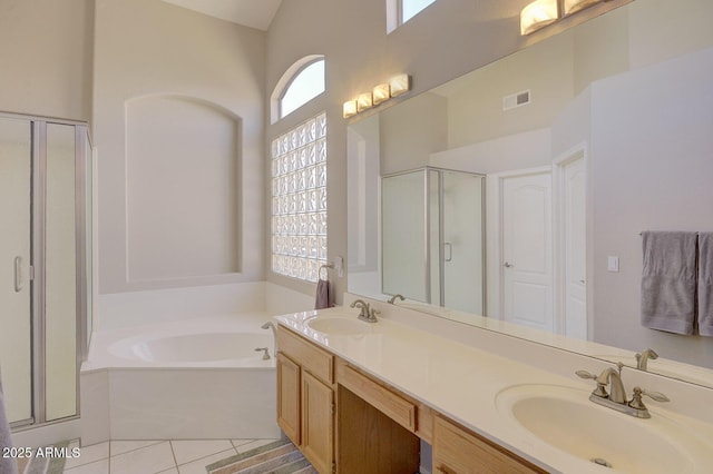 bathroom featuring vanity, tile patterned floors, plus walk in shower, and a high ceiling