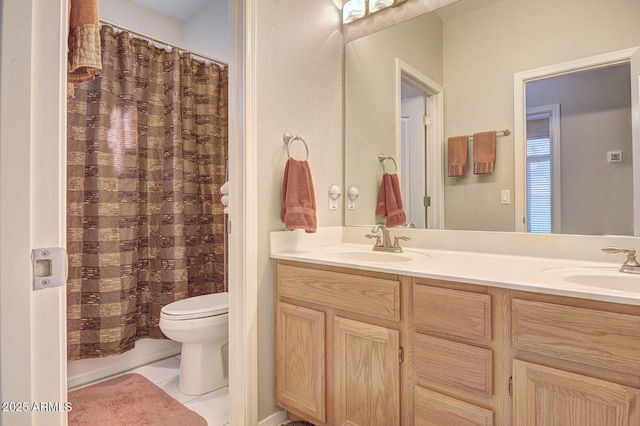 bathroom with vanity, tile patterned flooring, and toilet