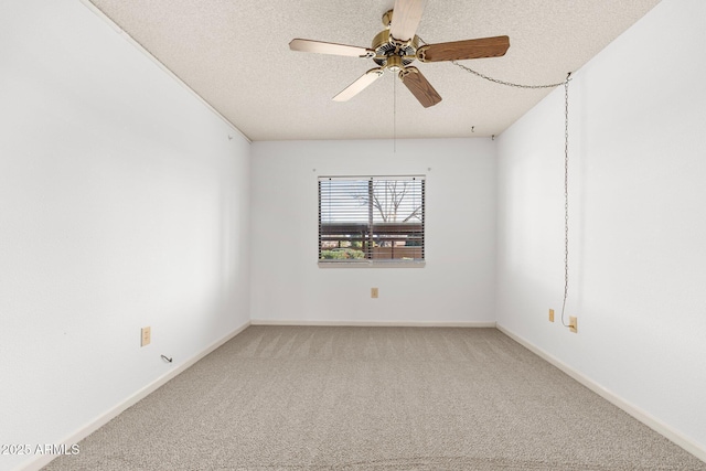 empty room featuring ceiling fan, carpet, and a textured ceiling