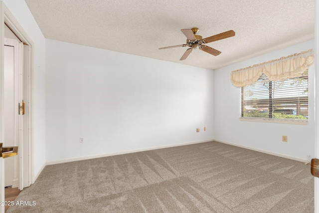 carpeted empty room featuring ceiling fan and a textured ceiling