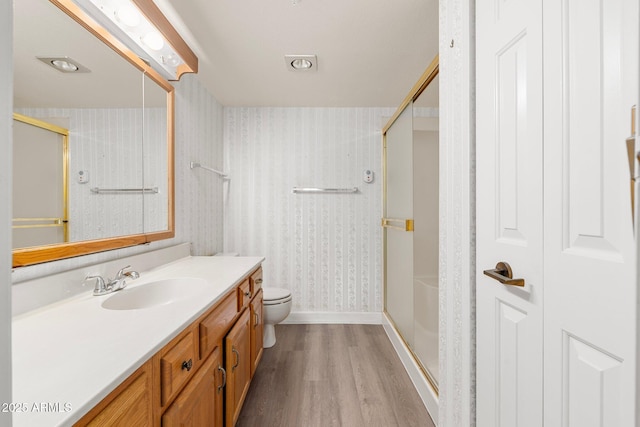 bathroom with a shower with door, wood-type flooring, vanity, and toilet