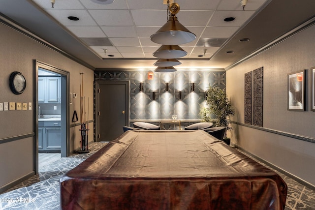 rec room featuring ornamental molding and a paneled ceiling