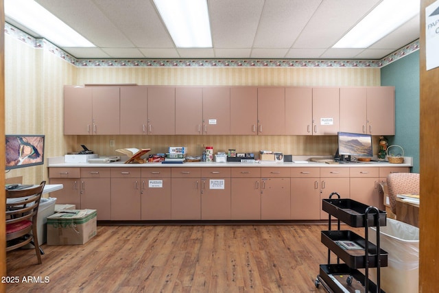 kitchen featuring light hardwood / wood-style flooring and a paneled ceiling