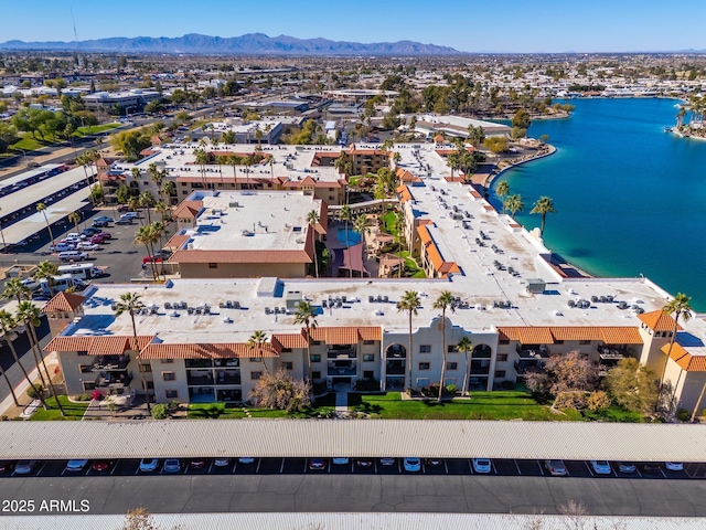 drone / aerial view with a water and mountain view