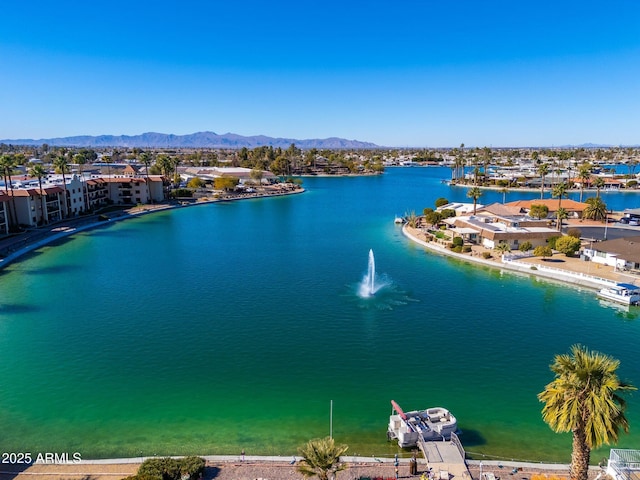 birds eye view of property featuring a water and mountain view