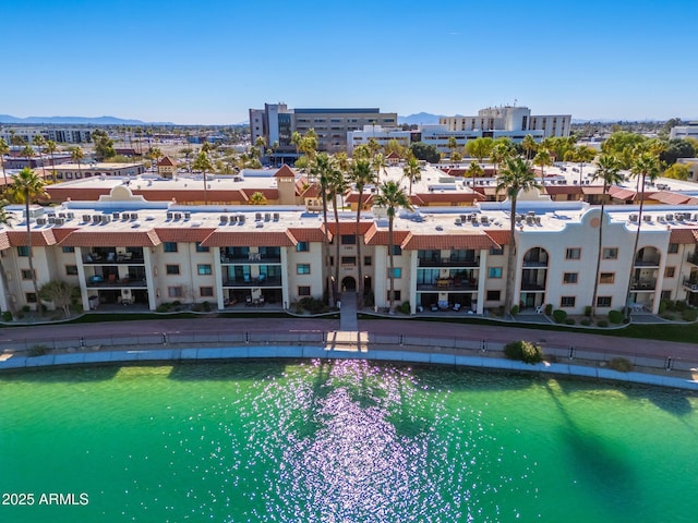 drone / aerial view featuring a water and mountain view