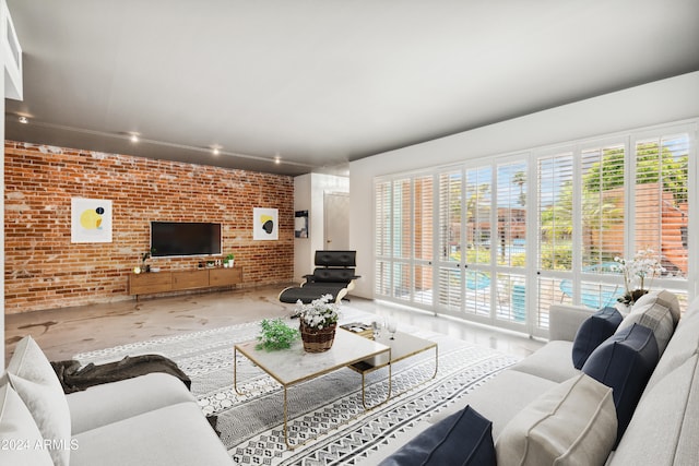 living room with a wealth of natural light and brick wall