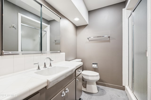 bathroom with decorative backsplash, vanity, toilet, and a shower with shower door