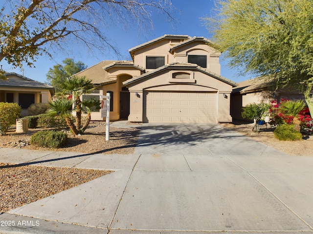 8022 S 48th Dr, Laveen, AZ 85339 - mediterranean / spanish-style home with stucco siding, driveway, a tile roof, and a garage