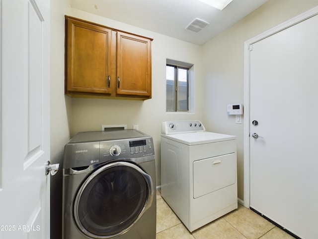 8022 S 48th Dr, Laveen, AZ 85339 - washroom with separate washer and dryer, cabinet space, and light tile patterned floors