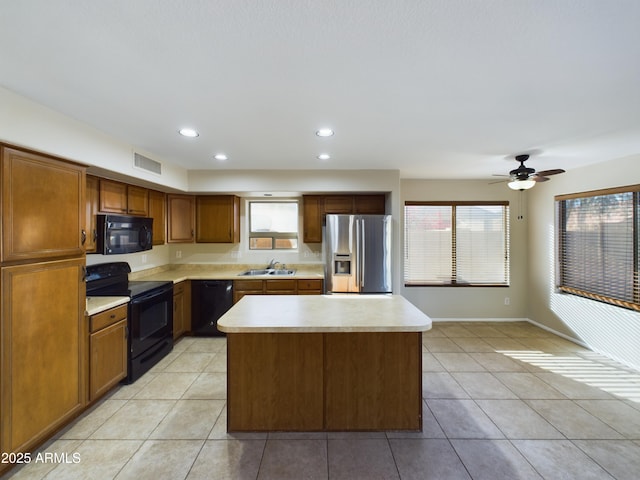 8022 S 48th Dr, Laveen, AZ 85339 - kitchen featuring black appliances, a sink, light countertops, light tile patterned floors, and recessed lighting
