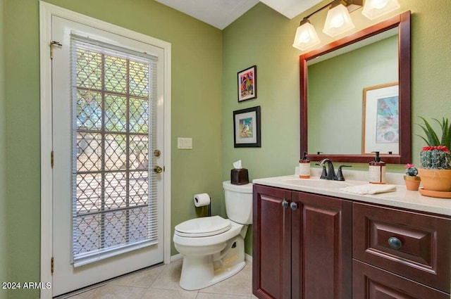 bathroom with tile patterned flooring, vanity, and toilet