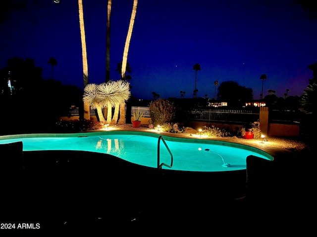 view of pool at night