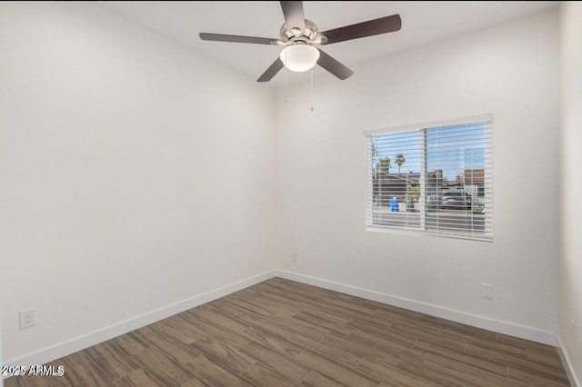 unfurnished room featuring baseboards, wood finished floors, and a ceiling fan