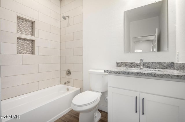bathroom featuring shower / tub combination, wood finished floors, toilet, and vanity