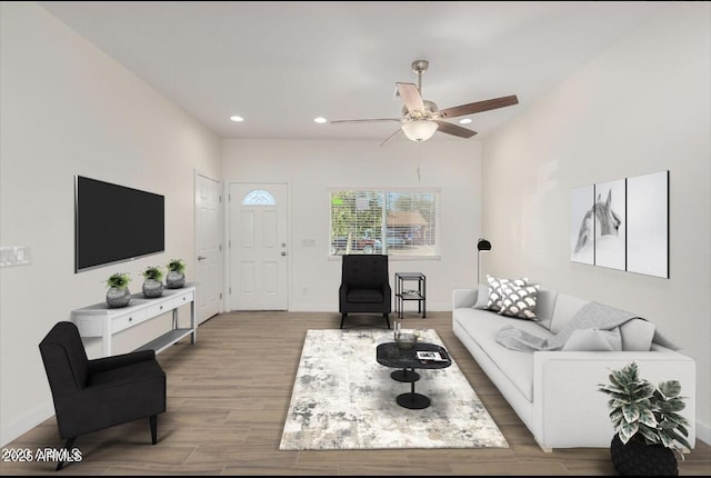 living area featuring baseboards, ceiling fan, wood finished floors, and recessed lighting