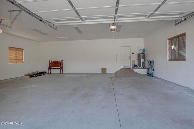 garage featuring a garage door opener and electric water heater