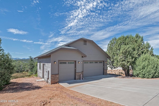 view of front of house with a garage and a mountain view