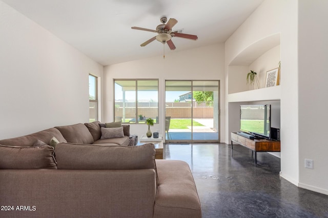 living room with ceiling fan, a healthy amount of sunlight, and vaulted ceiling