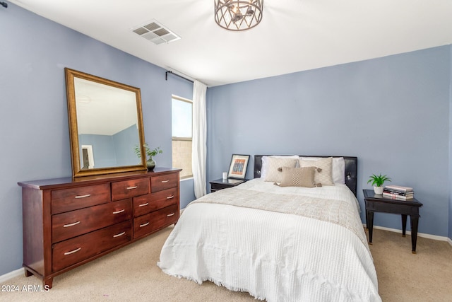 bedroom featuring light colored carpet