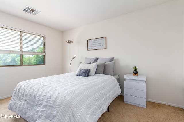 bedroom featuring light colored carpet