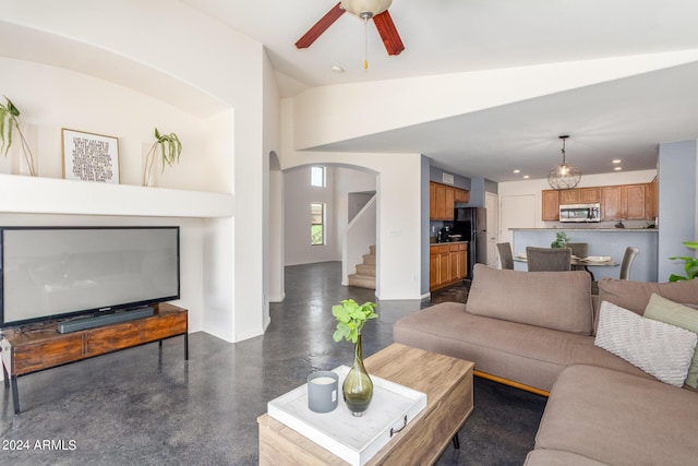 living room featuring vaulted ceiling and ceiling fan