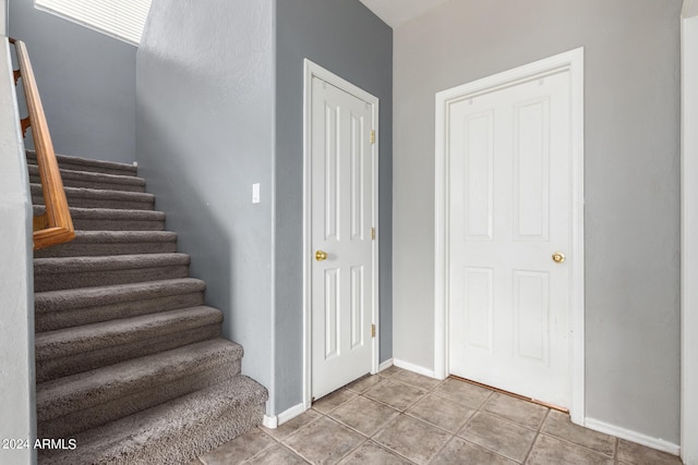 stairway with tile patterned flooring