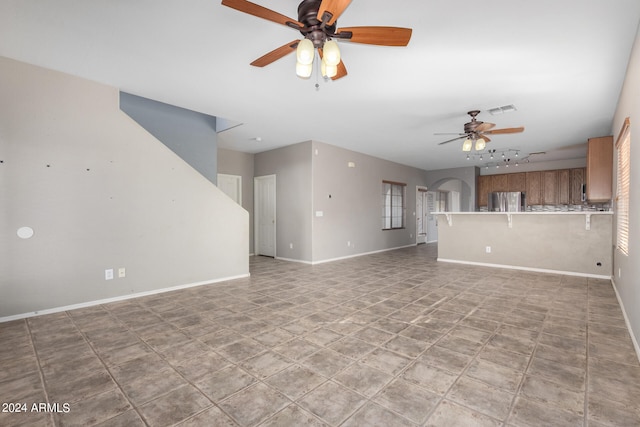 unfurnished living room with light tile patterned flooring and ceiling fan