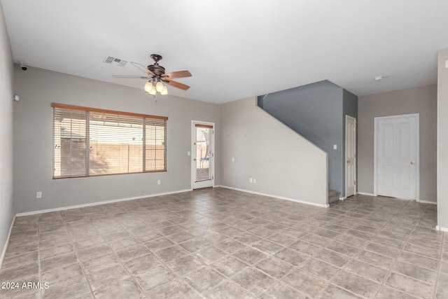 unfurnished living room featuring ceiling fan and light tile patterned floors