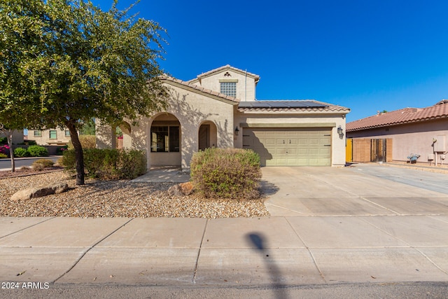 mediterranean / spanish home featuring a garage