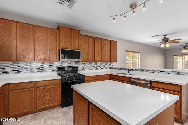 kitchen featuring appliances with stainless steel finishes, plenty of natural light, decorative backsplash, and sink